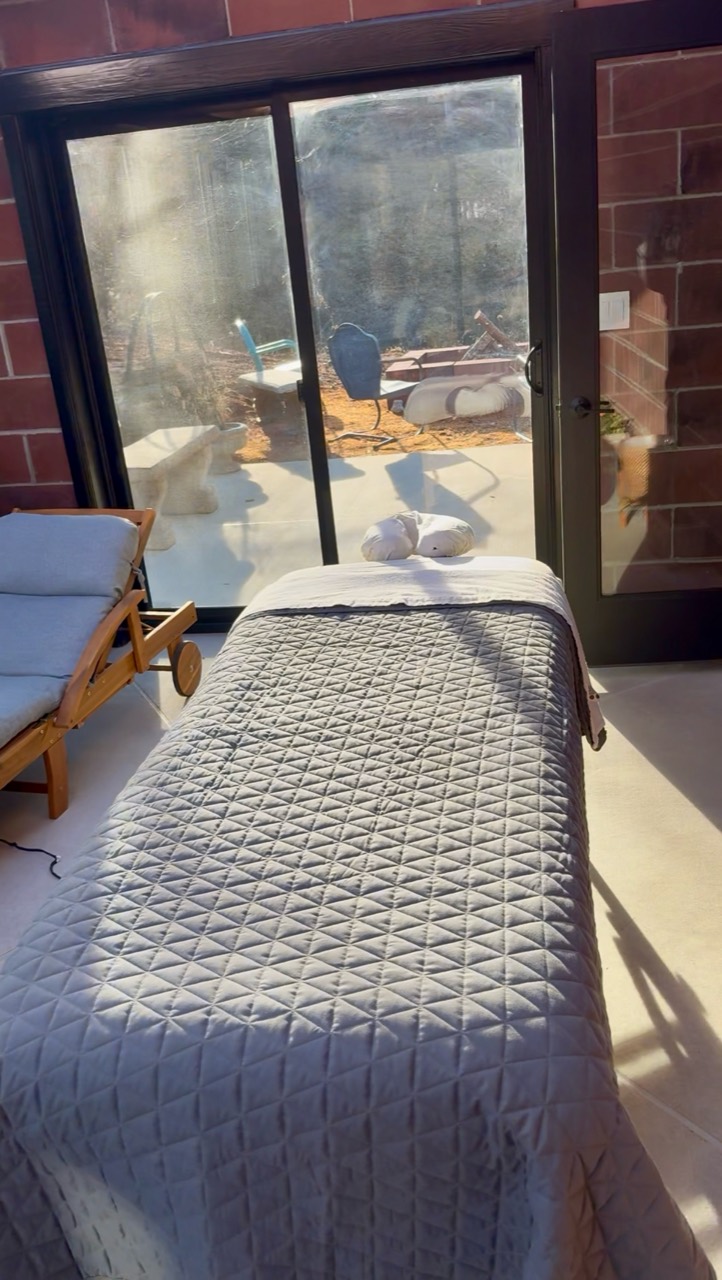Professional mobile massage table setup prepared for an in-home Capacity Reset session